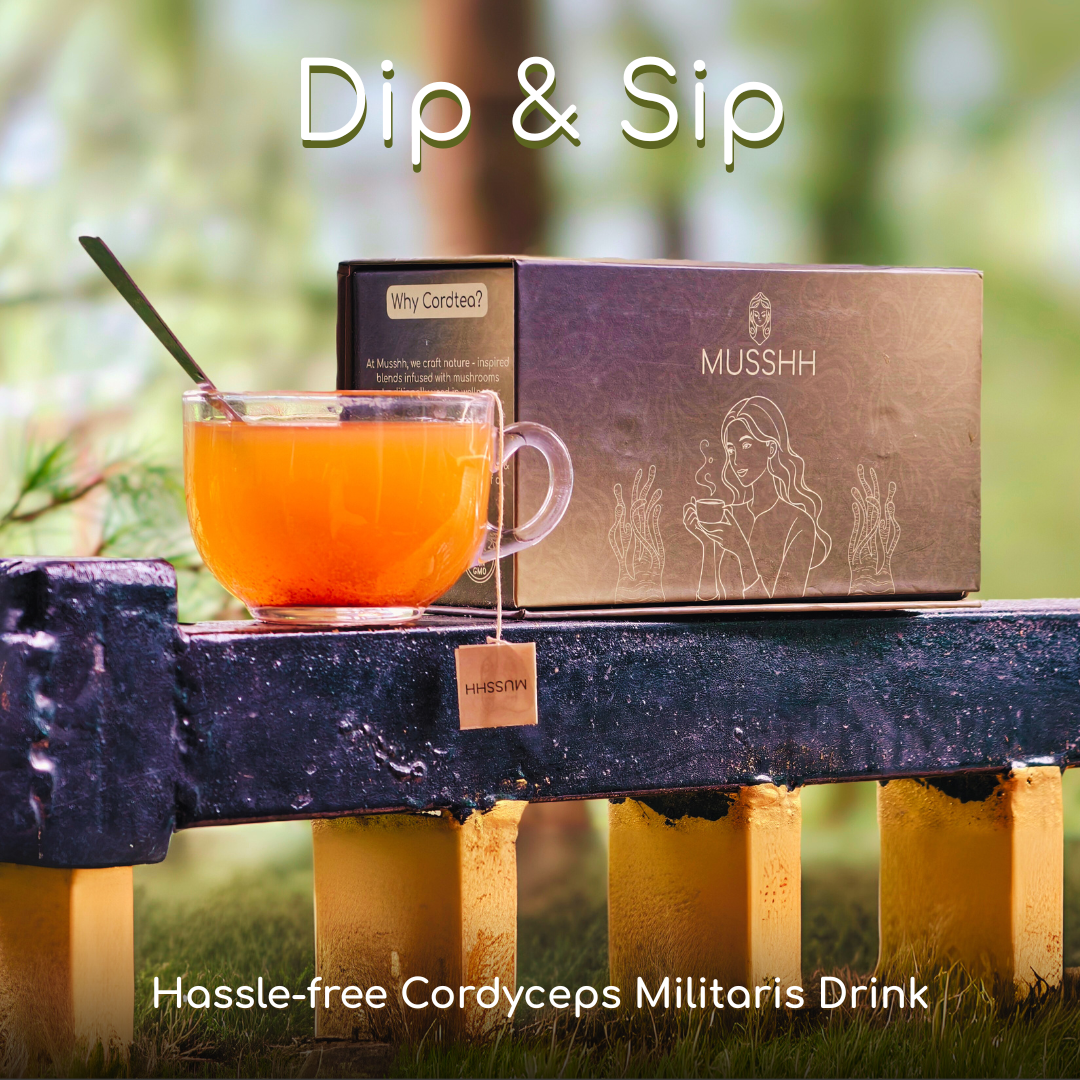 Mug of tea with a box labeled 'Musshh' on a wooden stand outdoors.