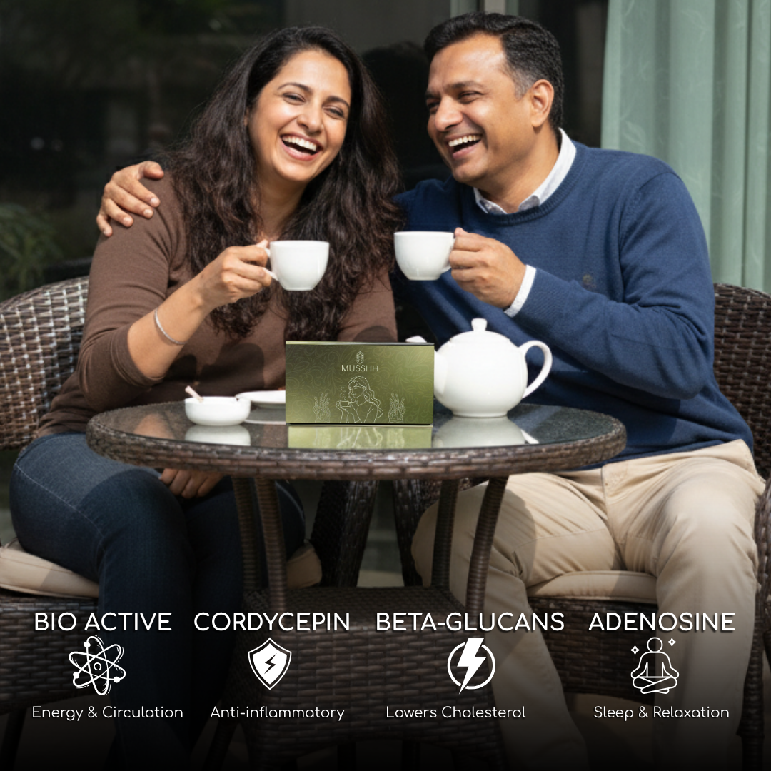 Couple enjoying tea outdoors with a box of tea in the center.